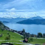a scenic view of a lake surrounded by mountains