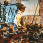 a man working on a machine in a factory