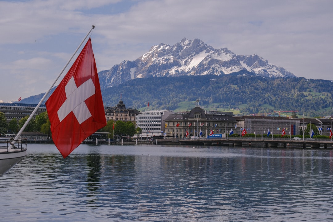 a swiss flag on a boat in the water