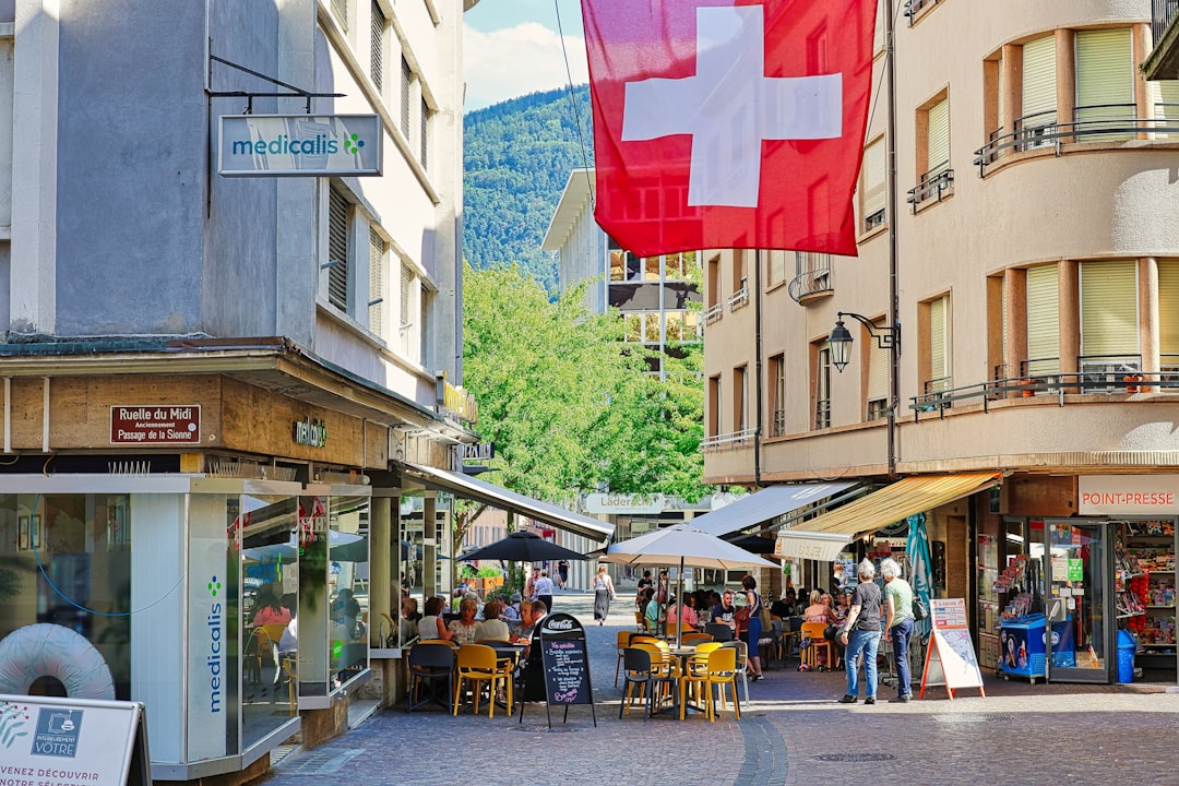 A red and white flag flying over a city street