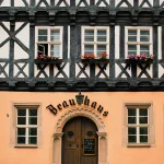 brown concrete building with black metal window frame
