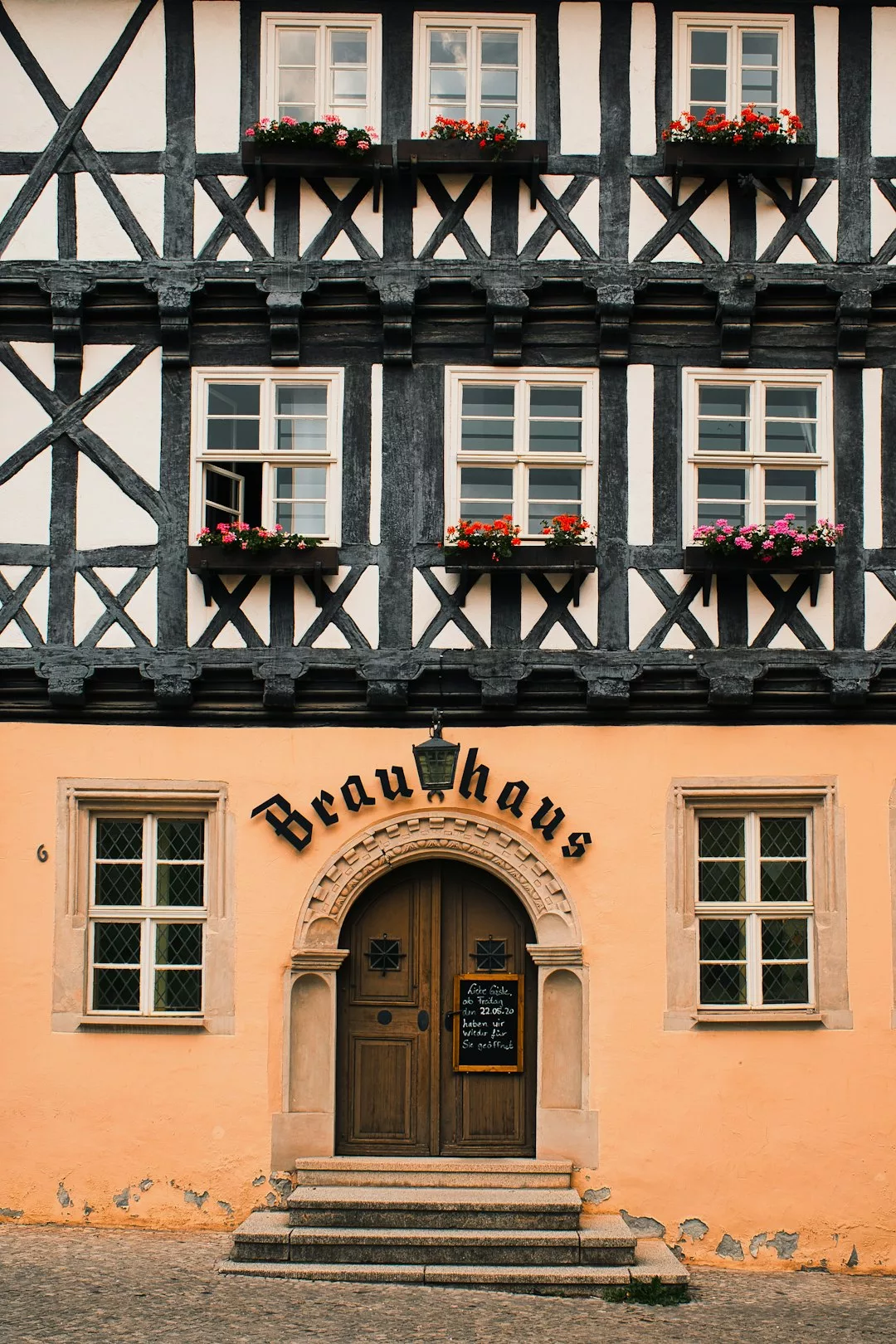brown concrete building with black metal window frame