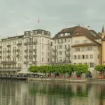 a row of buildings next to a body of water