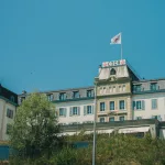 A tall building with a flag on top of it