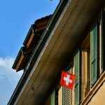 A red and white flag is hanging from the side of a building