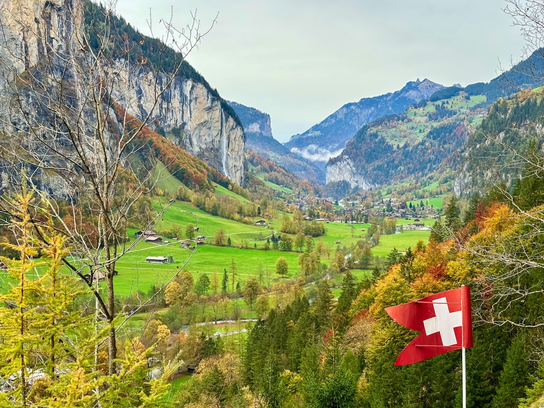 A swiss flag flying high in the mountains