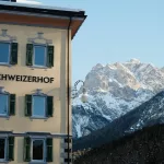 A hotel with a mountain in the background