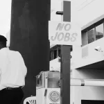 man in white dress shirt standing near white and black camera