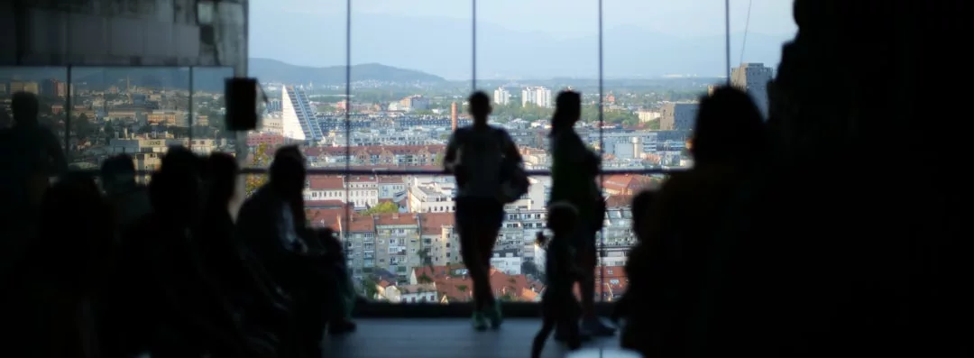 a group of people standing in front of a large screen
