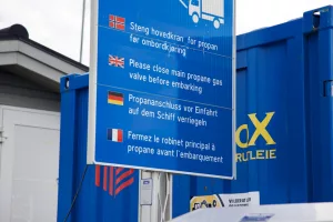 a blue sign with a white truck in the background